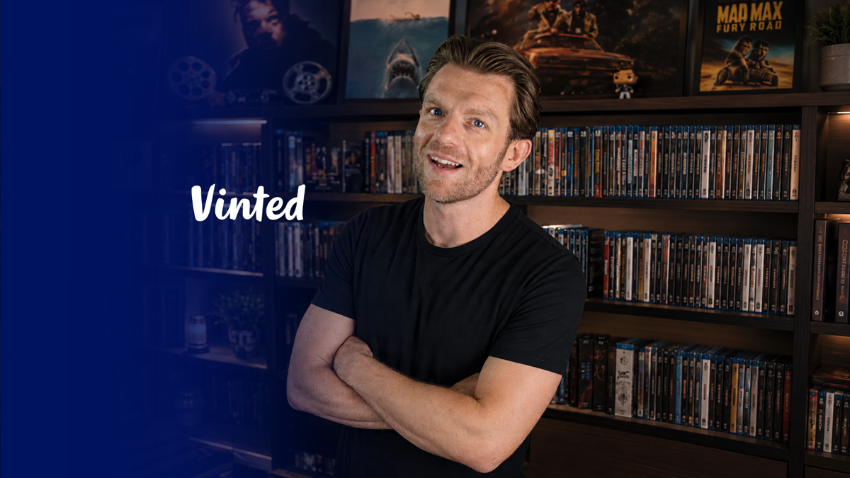 A man with short brown hair wearing a black t-shirt stands with arms crossed in front of shelves filled with DVDs, with movie posters on the wall behind him. The word 'Vinted' is written in white text on the left side against a dark blue background.