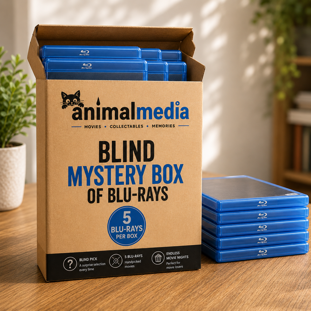 A cardboard mystery box labeled 'animalmedia BLIND MYSTERY BOX OF BLU-RAYS' stands open on a wooden table, with blue Blu-ray cases visible inside and a stack of matching blue cases beside it.