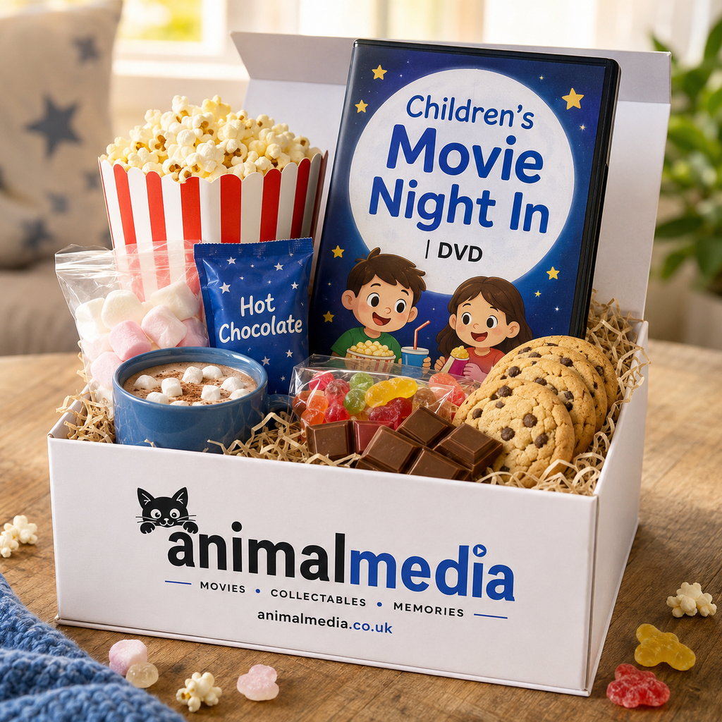 A curated gift box from Animal Media titled 'Children's Movie Night In' filled with snacks and a DVD. The white box is lined with shredded paper and contains a popcorn bucket, a blue bag of hot chocolate mix, marshmallows, chocolate bars, gummy candies, chocolate chips, and a DVD case with cartoon children on the cover.