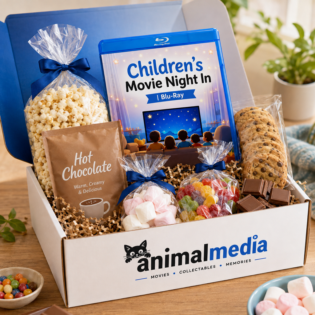 A curated gift box set from Animalmedia titled 'Children's Movie Night In', containing a Blu-ray, popcorn, hot chocolate, cookies, marshmallows, and gummy candies, arranged in a white box on a wooden table.