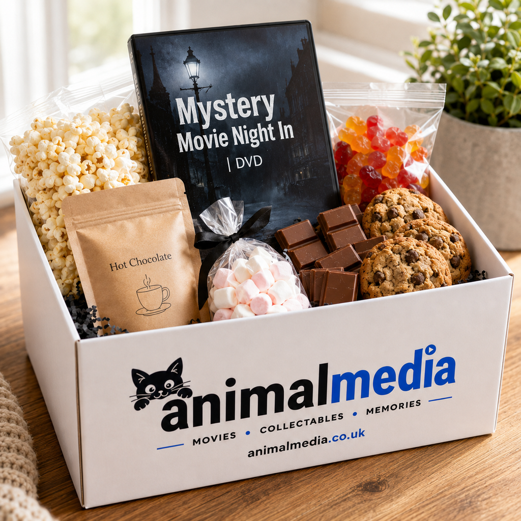 A curated gift box labeled Animal Media on a wooden table, filled with popcorn, a hot chocolate pouch, marshmallows, chocolate bars, cookies, gummy candies, and a DVD titled 'Mystery Movie Night In'.