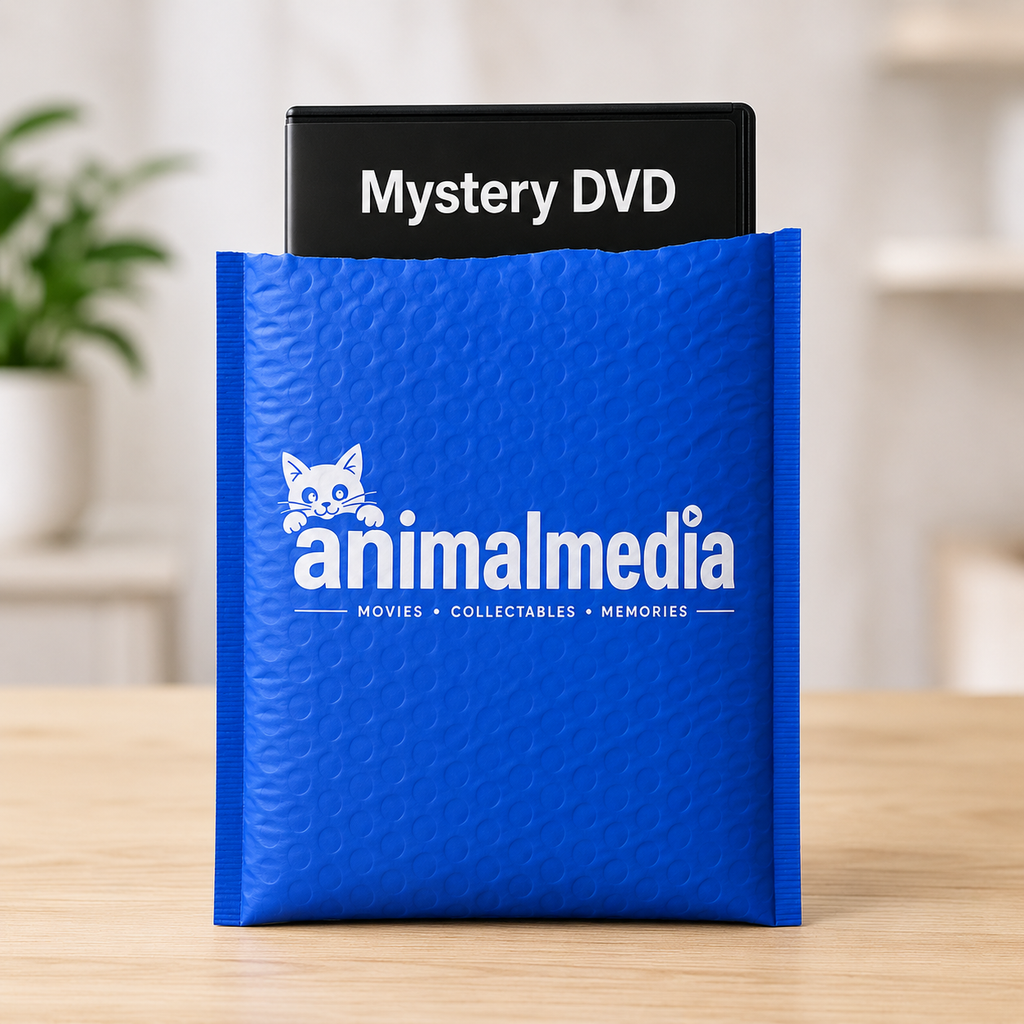 A bright blue bubble mailer envelope standing on a light wood surface, with a black DVD case labeled 'Mystery DVD' partially tucked inside. The envelope has a white 'animalmedia' logo and text on the front.