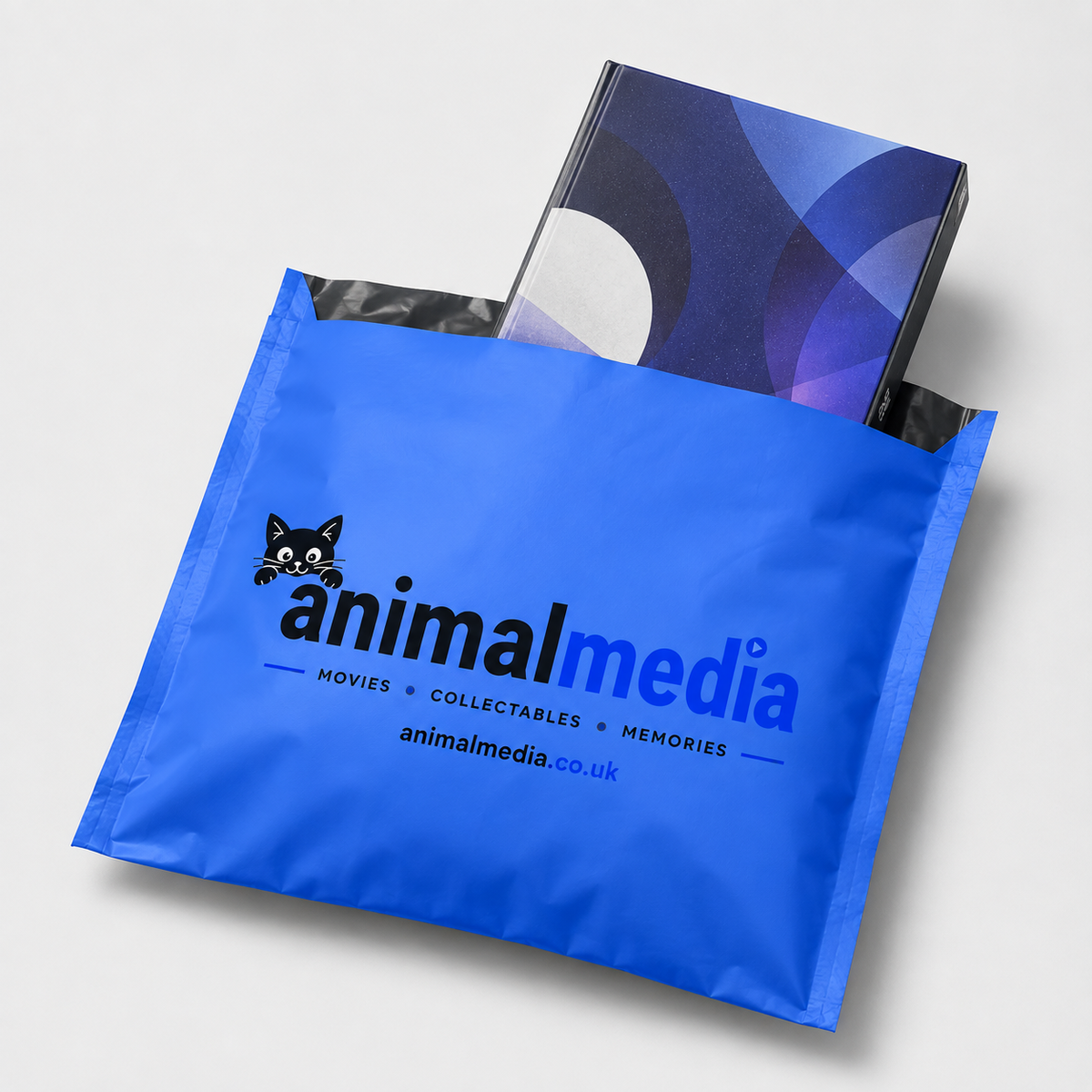 A bright blue Animal Media box or mailer bag with the brand name printed in black and blue, holding a dark collectible box with a blue and purple abstract cover design, photographed on a light gray background.